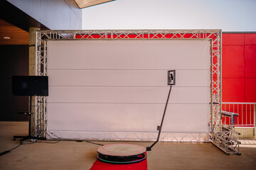 Valmiera, Latvia - July - 6, 2024 - 360 photobooth setup with a white backdrop, lighting equipment,...