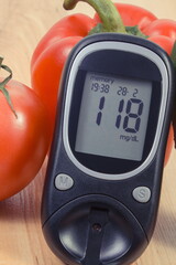 Glucometer with result of sugar level and fresh natural vegetables. Healthy nutrition during...