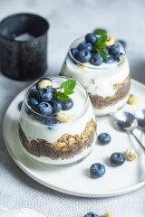 Granola with yogurt, chia and blueberries in a glass