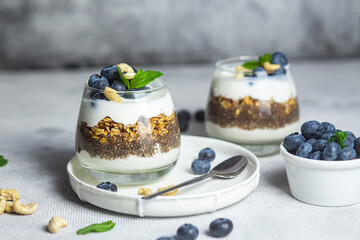 Granola with yogurt, chia and blueberries in a glass