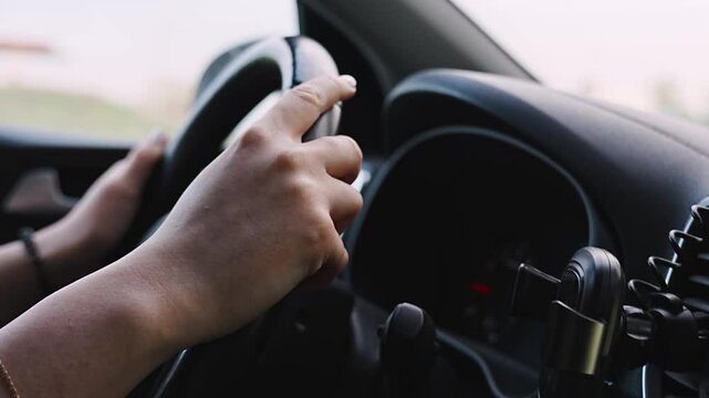 without a face. A woman is driving a car. an inexperienced driver. 