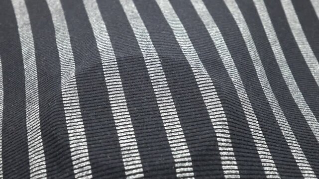 Gray and black striped ribbed fabric, uneven background