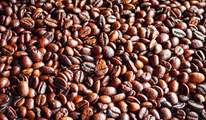 Top view of backdrop dark brown coffee beans and Textured background of freshly roasted coffee beans