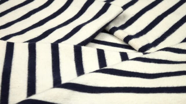 Thick folded randomly white fabric with thin black stripes, background