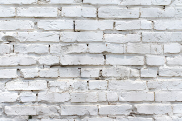White brick wall background. Rustic, textured surface with rough bricks. Ideal for design, construction themes, and architectural projects.