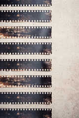 Vintage film strips with grunge texture on a light background, perfect for classic cinema or graphy themes and nostalgic media projects.