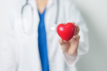 Doctor hand holding red heart shape in hospital. love, donor, world heart day, world health day, CSR donation and Insurance concepts