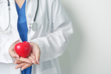 Doctor hand holding red heart shape in hospital. love, donor, world heart day, world health day, CSR donation and Insurance concepts