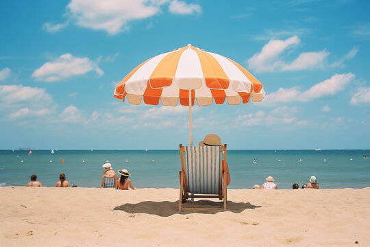 Beach scene with people relaxing under a colorful umbrella on a sunny seaside day