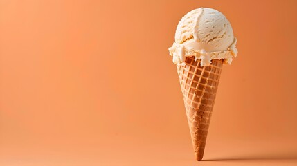 Light Brown Ice Cream Cone on an orange Background with Copy Space