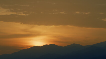 Sunrise Background Over The Mountain. Mountains Silhouette And Cloud. Real time.