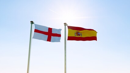 Spain and England Flags are waving in the spring of the blue sky. ULTRA HD. 