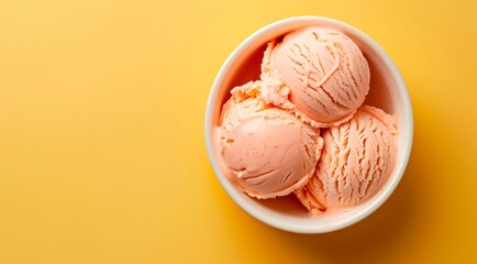 Bowl of ice cream scoops on yellow background, top view. Minimal flat lay style, copy space.