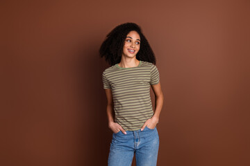 Photo of adorable lovely girl wear khaki t-shirt smiling looking empty space isolated brown color background
