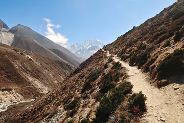 Trail along a steep hill next to Lobuche river between Pheriche and Pangboche village, Mount Kangtega and Thamserku in the background, Mount Everest Base Camp Trek, EBC, Nepal