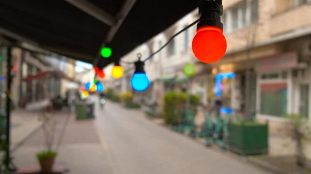 Festival lantern on cafe street. A festival cafe fasade with burning lanters against city buildings.