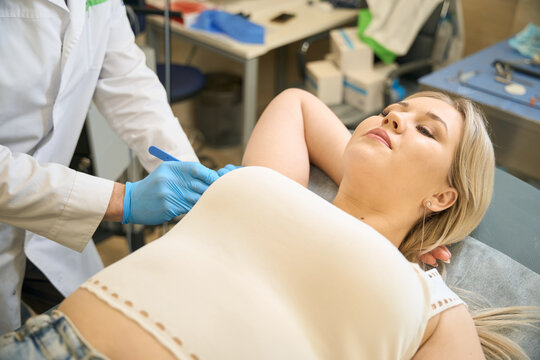 Female patient undergoing surgical treatment of axillary hidradenitis in clinic
