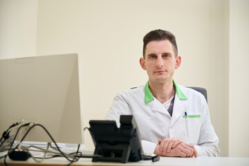 Physician posing for camera in his office