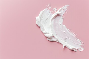 A close-up of a white substance on a pink surface, possibly a makeup or skincare product