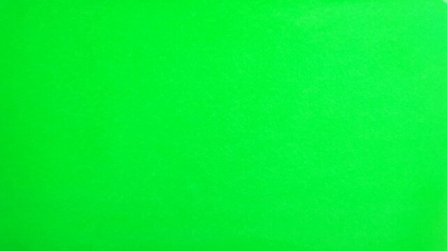 Squeezing the screen then throwing it away hand gesture isolated on green screen background chroma key