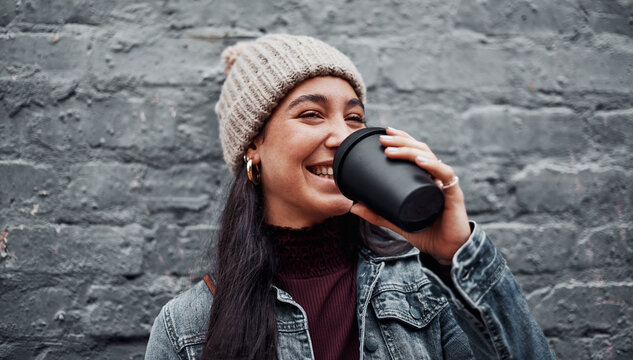 Grey wall, smile and woman with coffee, portrait and warm with break, happiness and outdoor. Face, New York and girl with herbal tea, holiday and cheerful with espresso, cappuccino and latte