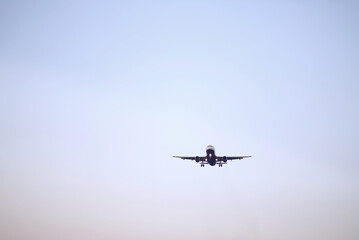 Passenger Airplane Landing Take-Off at Dawn with Clear Sky Background