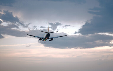 Passenger Airplane Landing Take-Off at Sunrise Dawn