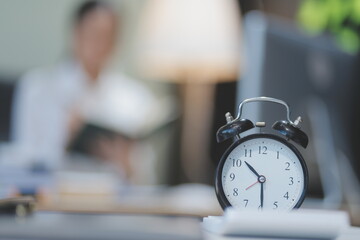 Young adorable Asian businesswoman working with work document during the night, working overtime at...