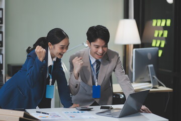 Group of Asia young creative people in smart casual wear discussing business celebrate giving five after dealing feeling happy and signing contract or agreement in office. Coworker teamwork concept.