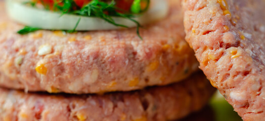 A piece of meat with a yellow cheese on it