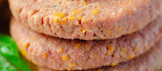 A piece of meat with a yellow cheese on it