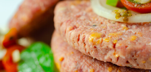 A piece of meat with a yellow cheese on it
