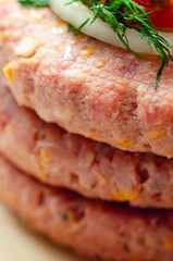 A piece of meat with a yellow cheese on it