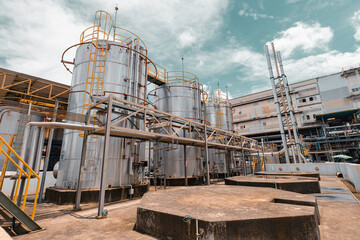 Obraz premium Stainless vertical steel tanks and pipes with pressure meter in equipment tank chemical cellar at the with stainless steel