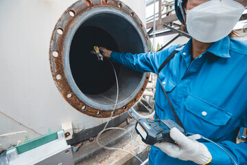 Worker female hand holding gas detector inspection safety gas testing at front manhole tank chemical