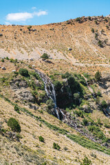 The scenic views of Gömbe Uçarsu Waterfall which  fly like a white cloud down the rocks at an altitude of about 50 meters, with a cave underneath, Gömbe, Kaş, Antalya