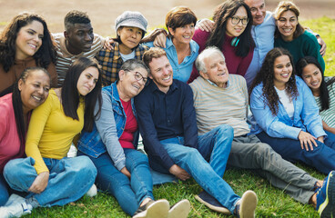 Crowd of multiracial people having fun hugging each others at city park - Social inclusion,...