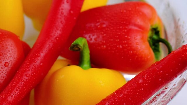 juicy red and yellow peppers in water