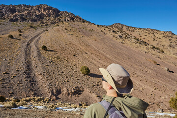 A tourist stands on the Atlas Mountains pass
