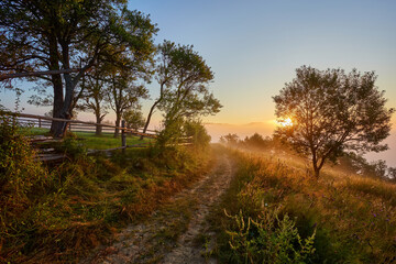 Foggy autumn scene of mountain willage with old wooden house in garden. Calm morning view of Carpathian Mountains, Ukraine, Europe.