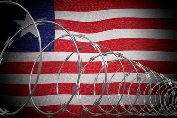 Obraz premium Spiral barbed wire and flag of Liberia - 3d illustration
