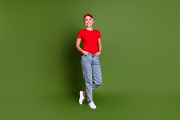 Full body photo of mature woman professional delivery employee confident wear red uniform workwear isolated on khaki color background