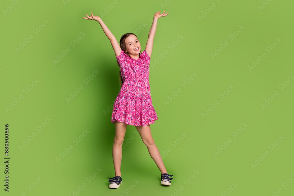 Poster full size photo of cute schoolgirl dance raise arms empty space wear pink dress isolated on green co