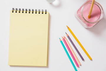 Notebook mock up with colorful pencils