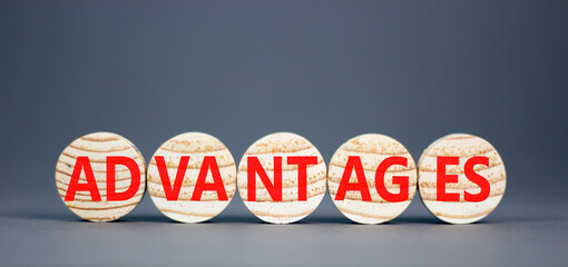 Advantages symbol. Concept word Advantages on beautiful wooden circles. Beautiful grey background. Business advantages concept. Copy space.