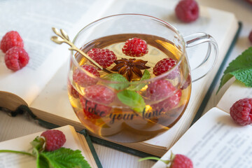 Fruit red tea with berries in glass cup on white background