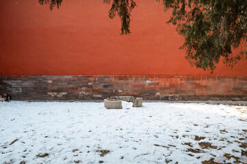 Snow and red palace walls at the Forbidden City in Beijing in winter
