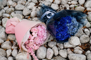 Dark blue and soft pink flowers in bouquets on gray stones