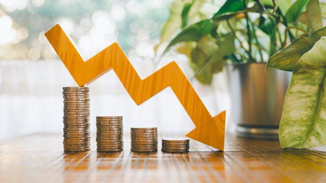 Down arrow with coin stack. Key concepts for success, methods, systems of raising or lowering Fed interest rates to correct inflation concepts.