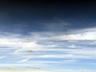 Fluffy White Clouds in a Blue Sky as A Skyscape Background